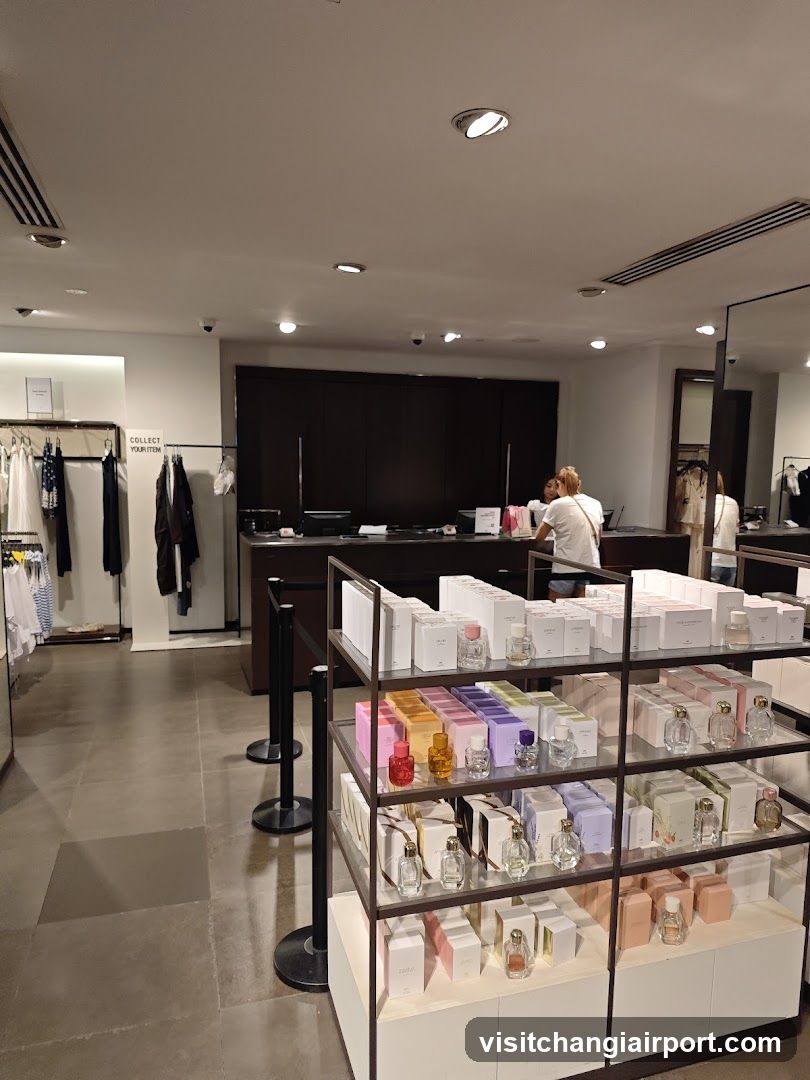 Interior of a retail store with perfume display and clothing racks