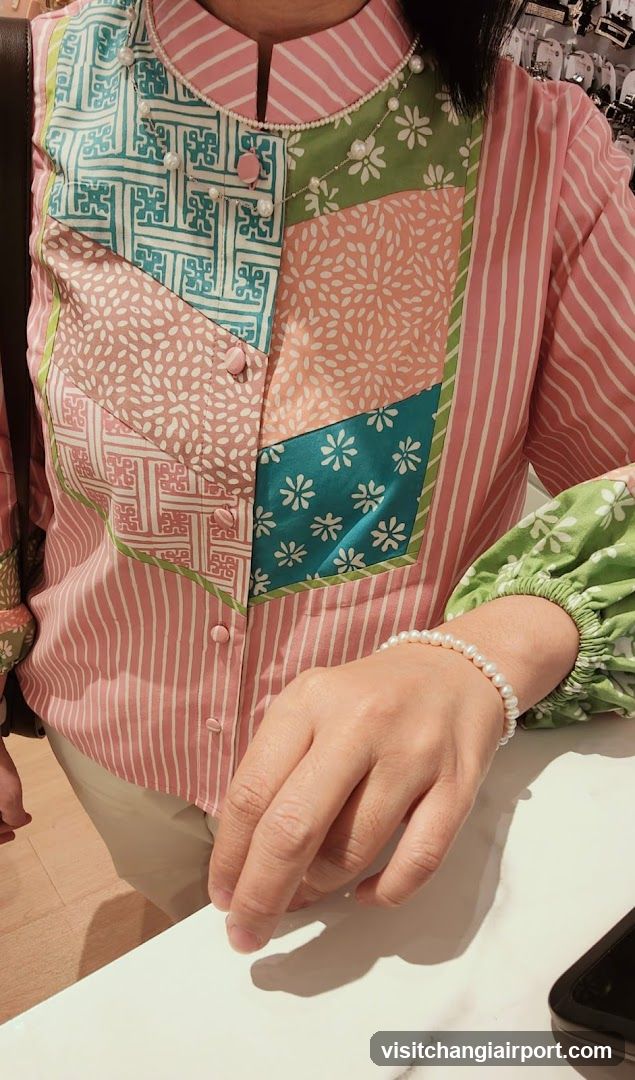 Person wearing colorful patchwork blouse