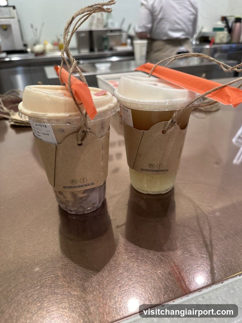 Two iced beverages in branded cups