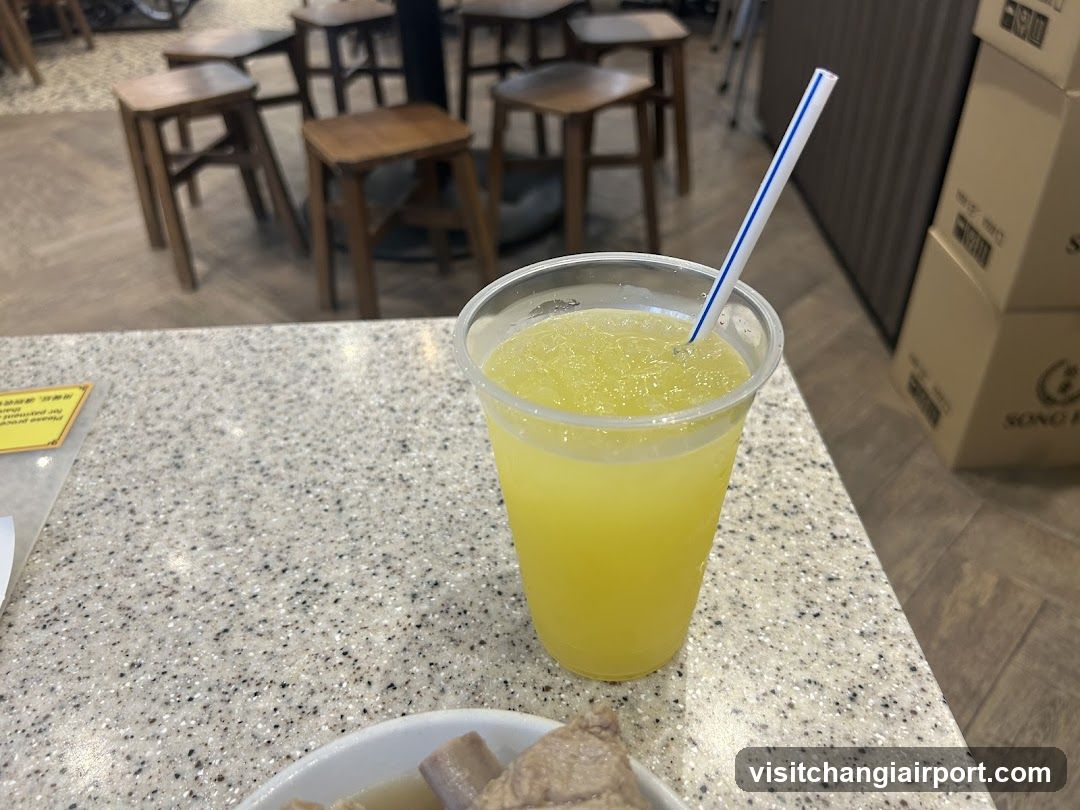 Yellow Drink with Straw on Speckled Counter