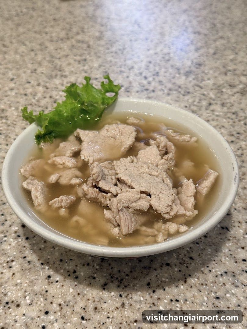 Bowl of Meat Soup with Lettuce Garnish