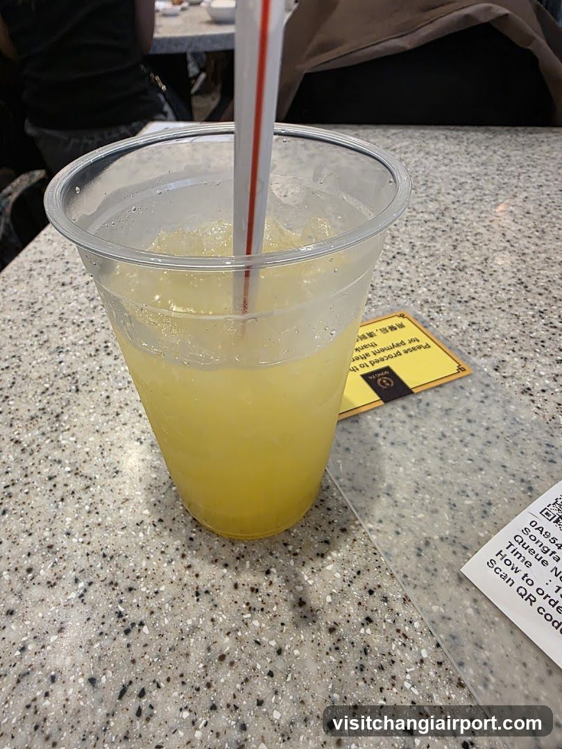 Yellow Drink in Plastic Cup