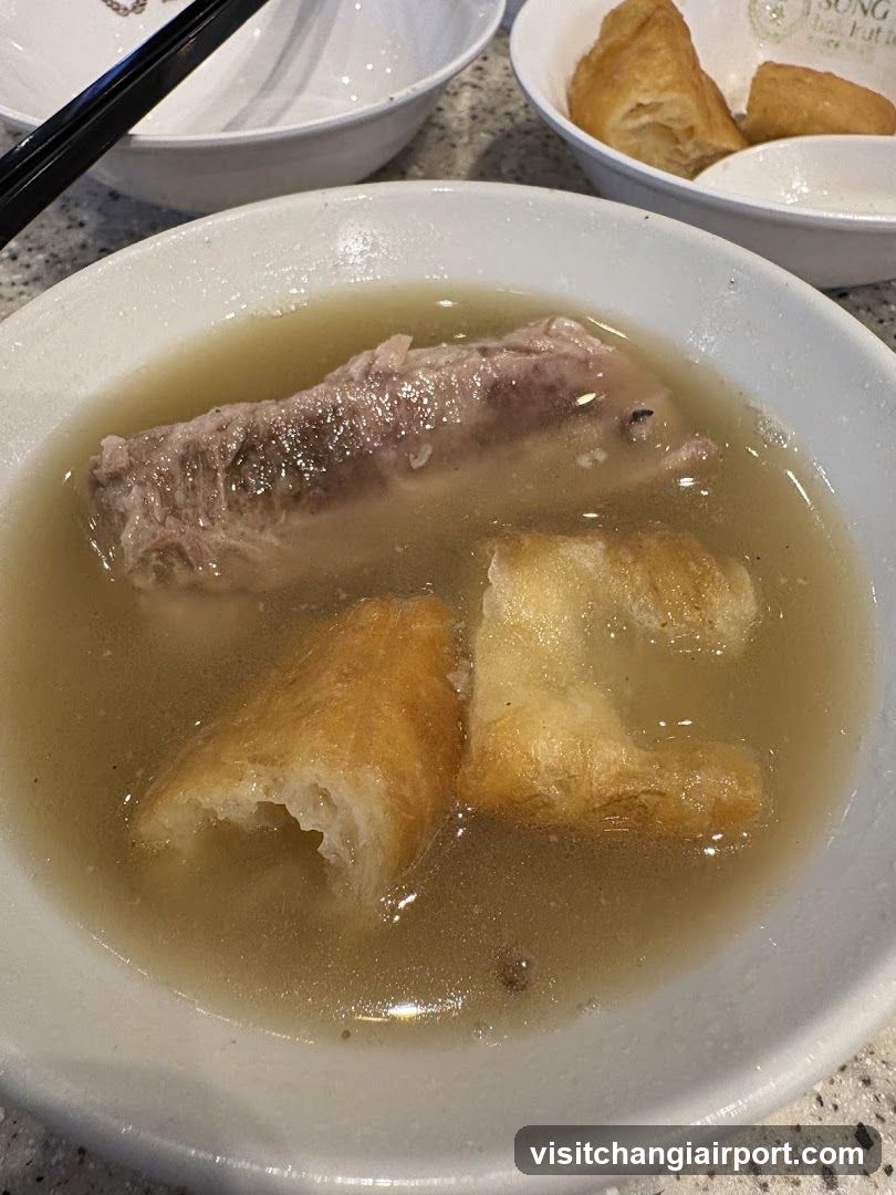 Bowl of Soup with Meat and Fried Dough