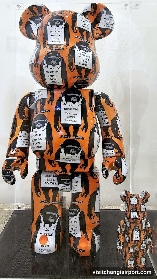 Bearbrick Display with 'Do Nothing You'll Live Longer' Pattern