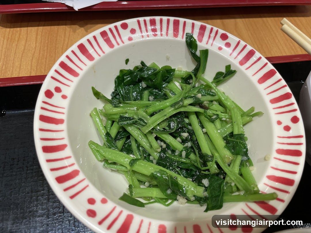 Bowl of stir-fried greens with garlic
