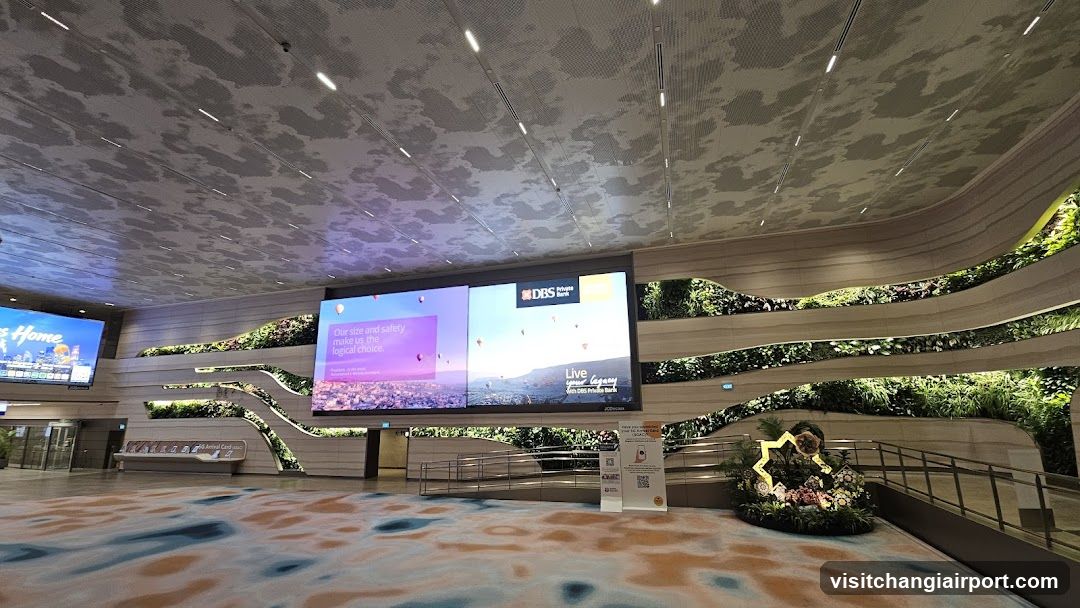 Indoor Public Space with Digital Screens and Greenery