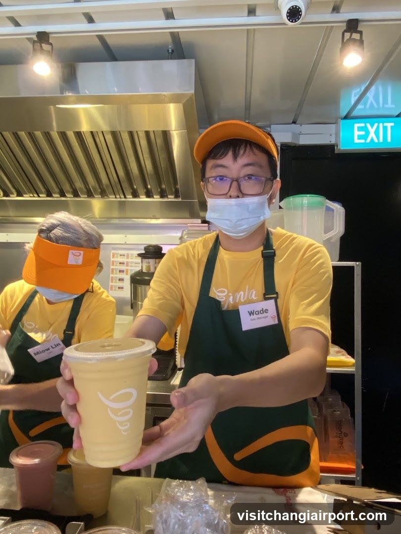 Staff serving a drink at a food stall