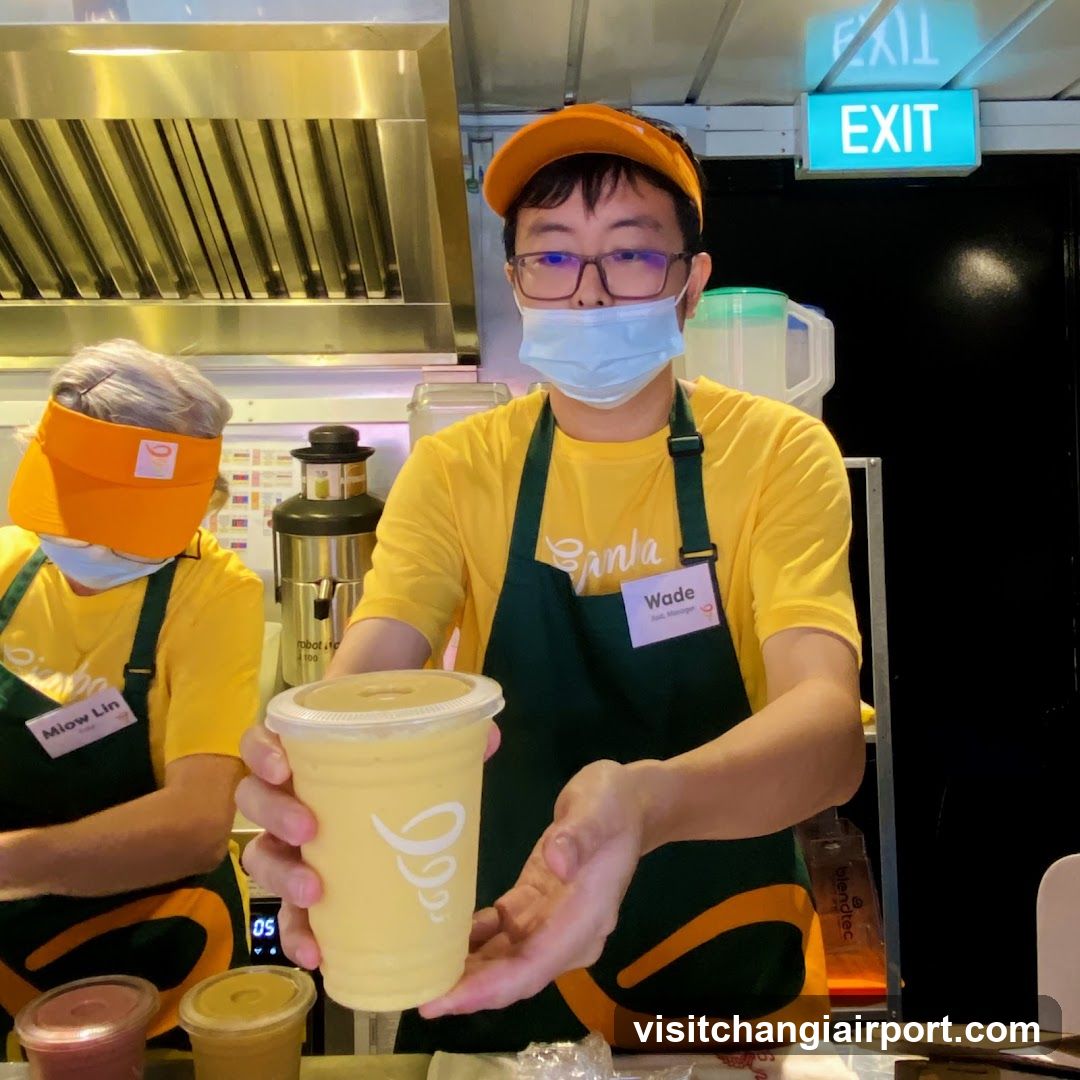 Staff holding a drink at food stall