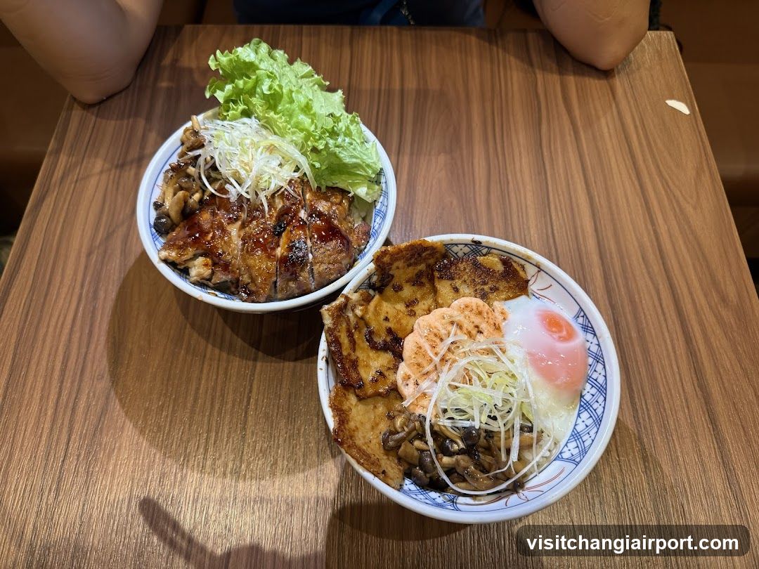 Two Bowls of Japanese-style Rice Dishes on Wooden Table