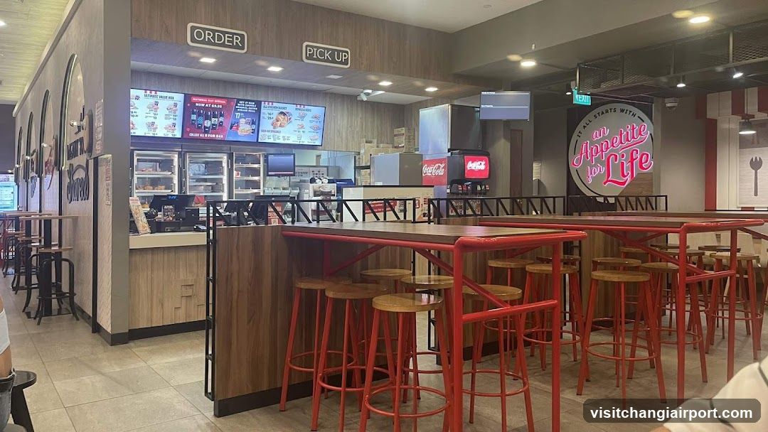 Food Court Interior with Red Tables and Stools