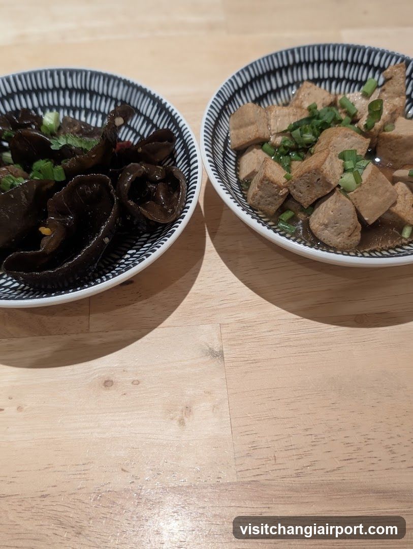 Two bowls of food on a wooden table