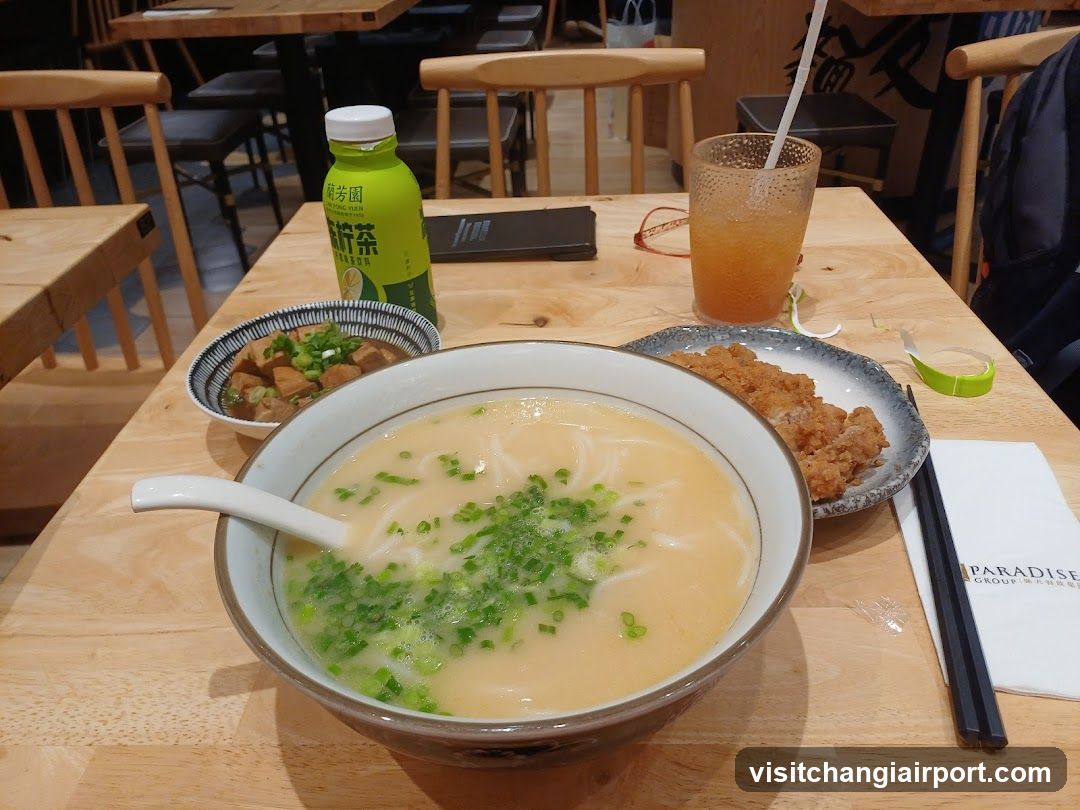 Dining Table with Noodles and Side Dishes