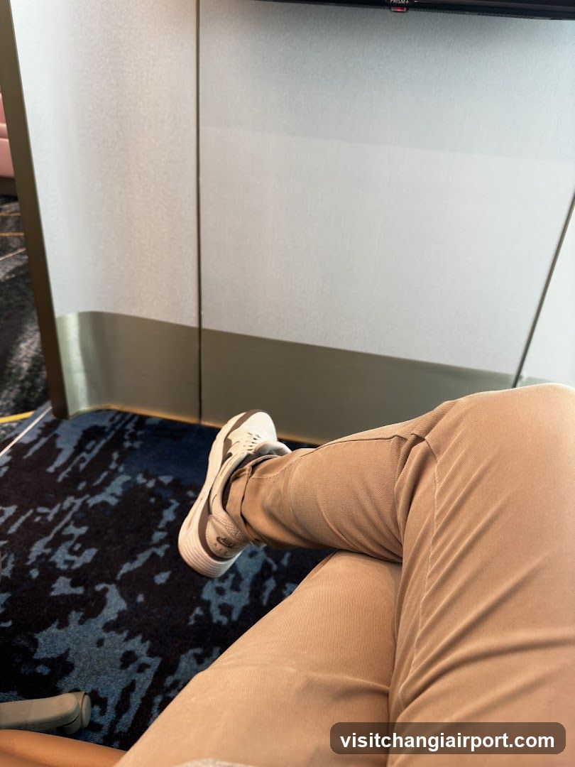 Person's legs resting on a chair in an indoor setting