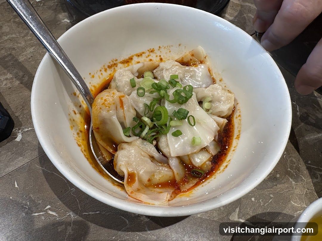 Bowl of Dumplings with Chili Oil and Scallions