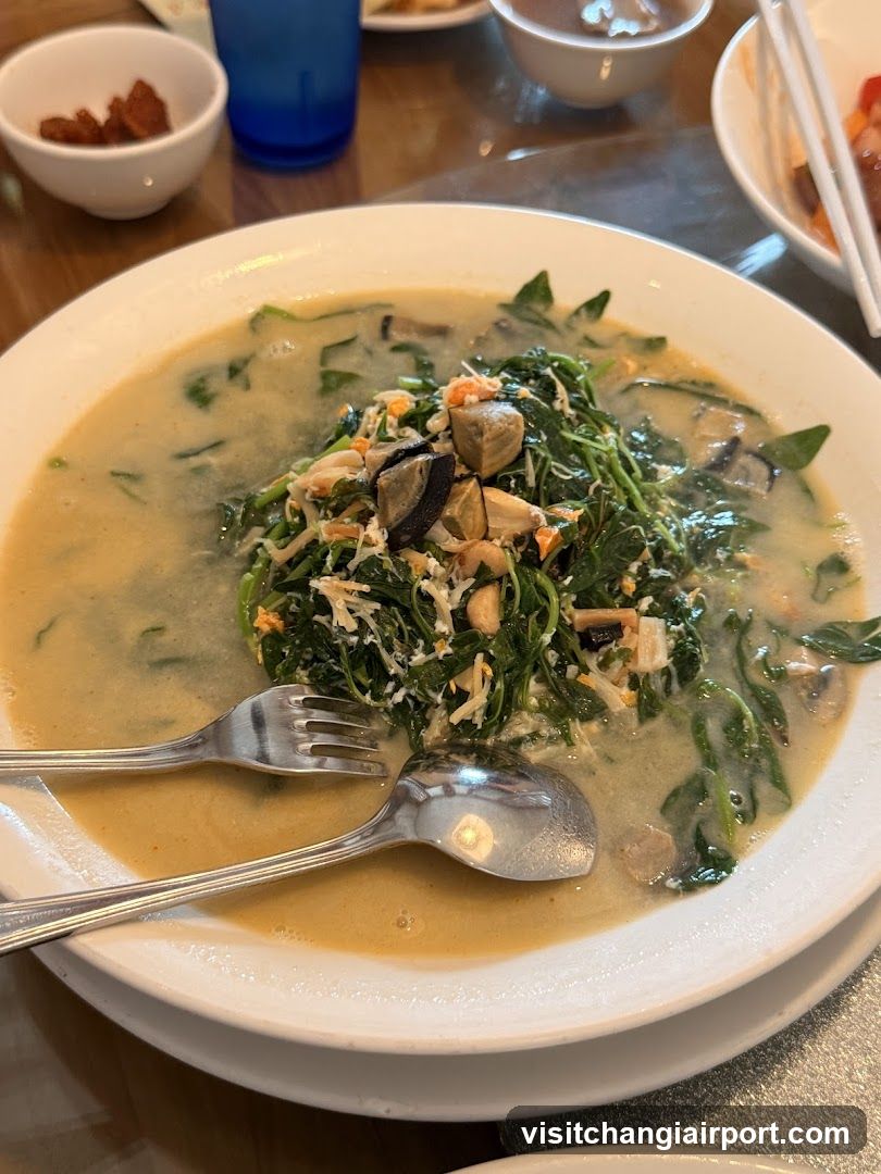 Bowl of Creamy Spinach Soup with Mushrooms and Clams