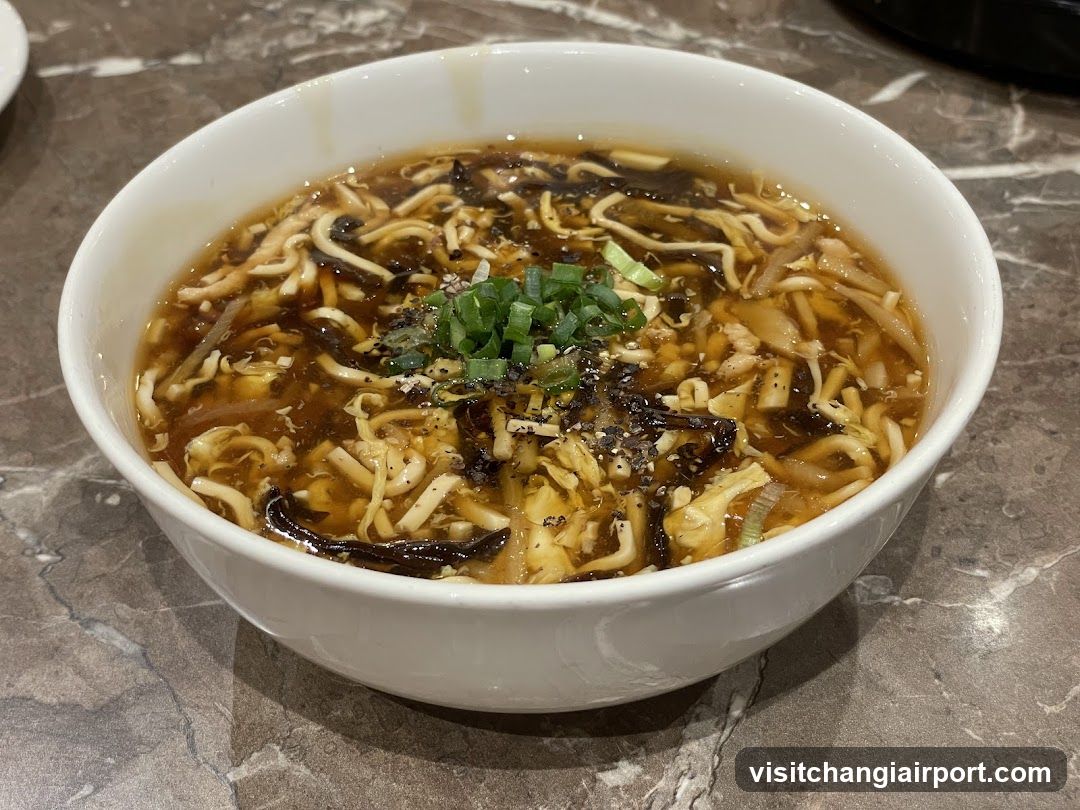 Bowl of Spicy Tofu Soup with Vermicelli and Green Onions