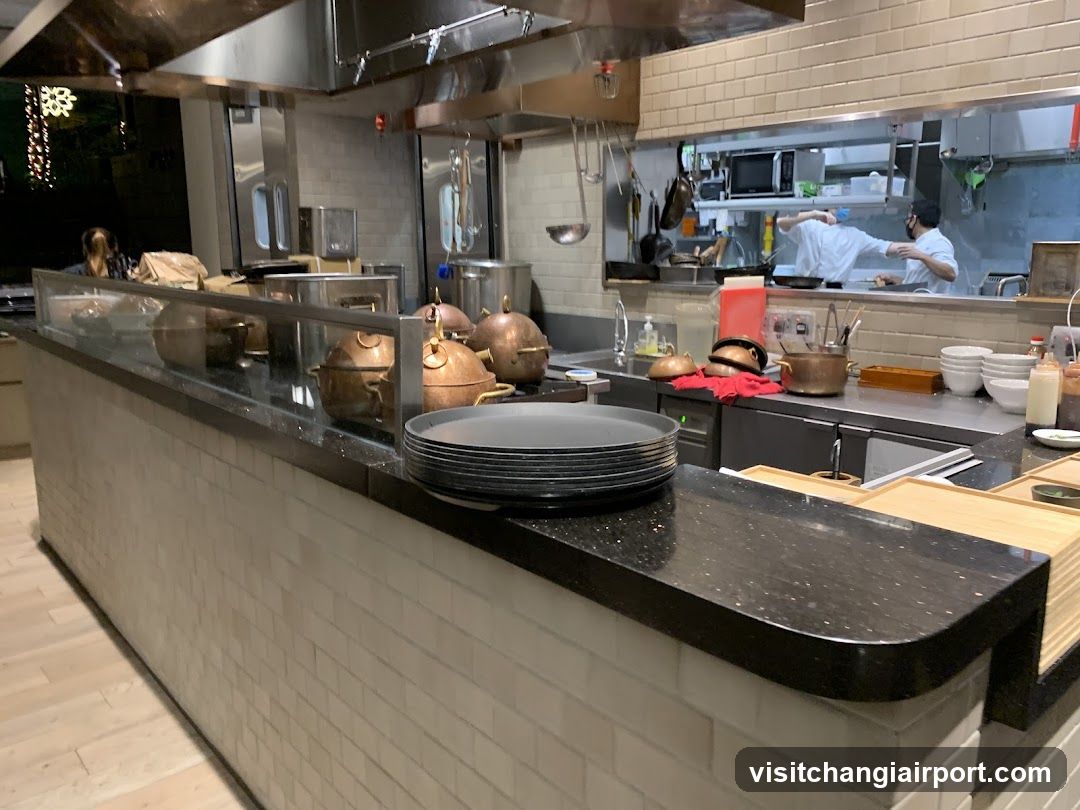 Kitchen Interior with Copper Pots and Staff