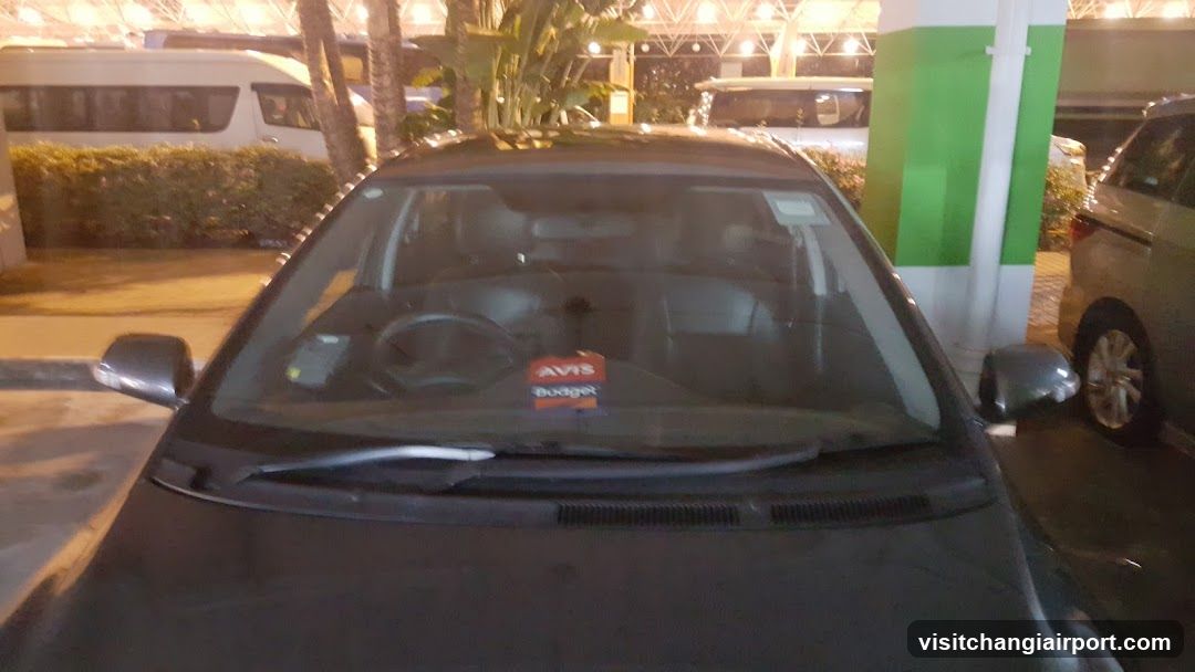 Car with Avis Budget sticker on windshield