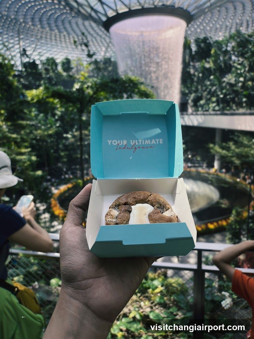 Pastry in a branded box held up indoors