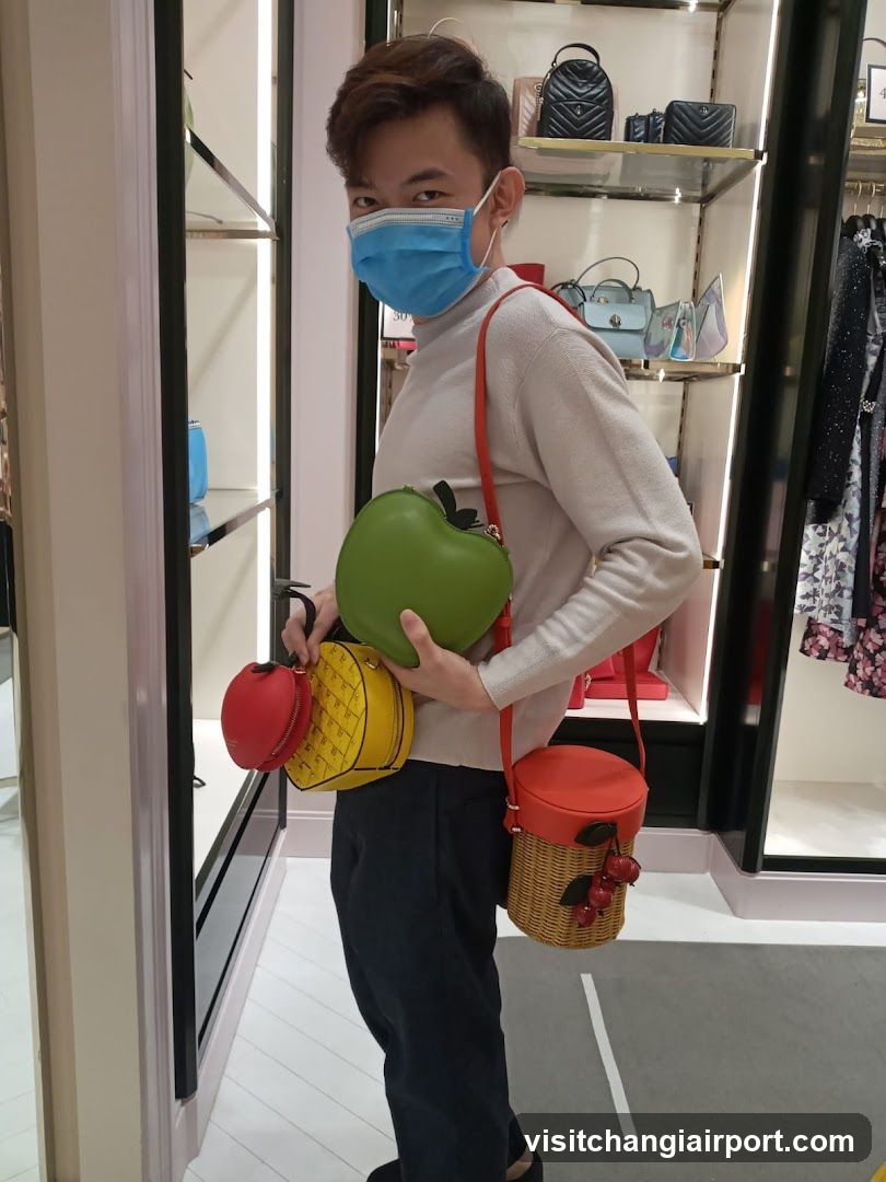 Person holding colorful fruit-shaped bags in a store