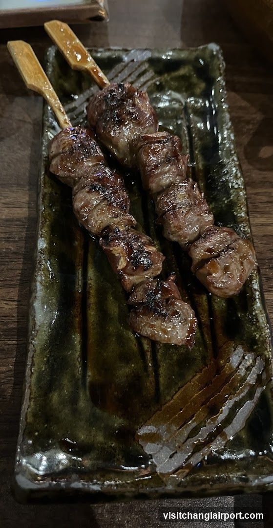 Grilled Meat Skewers on Ceramic Plate