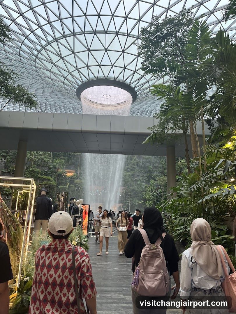 Indoor Waterfall Scene with Visitors