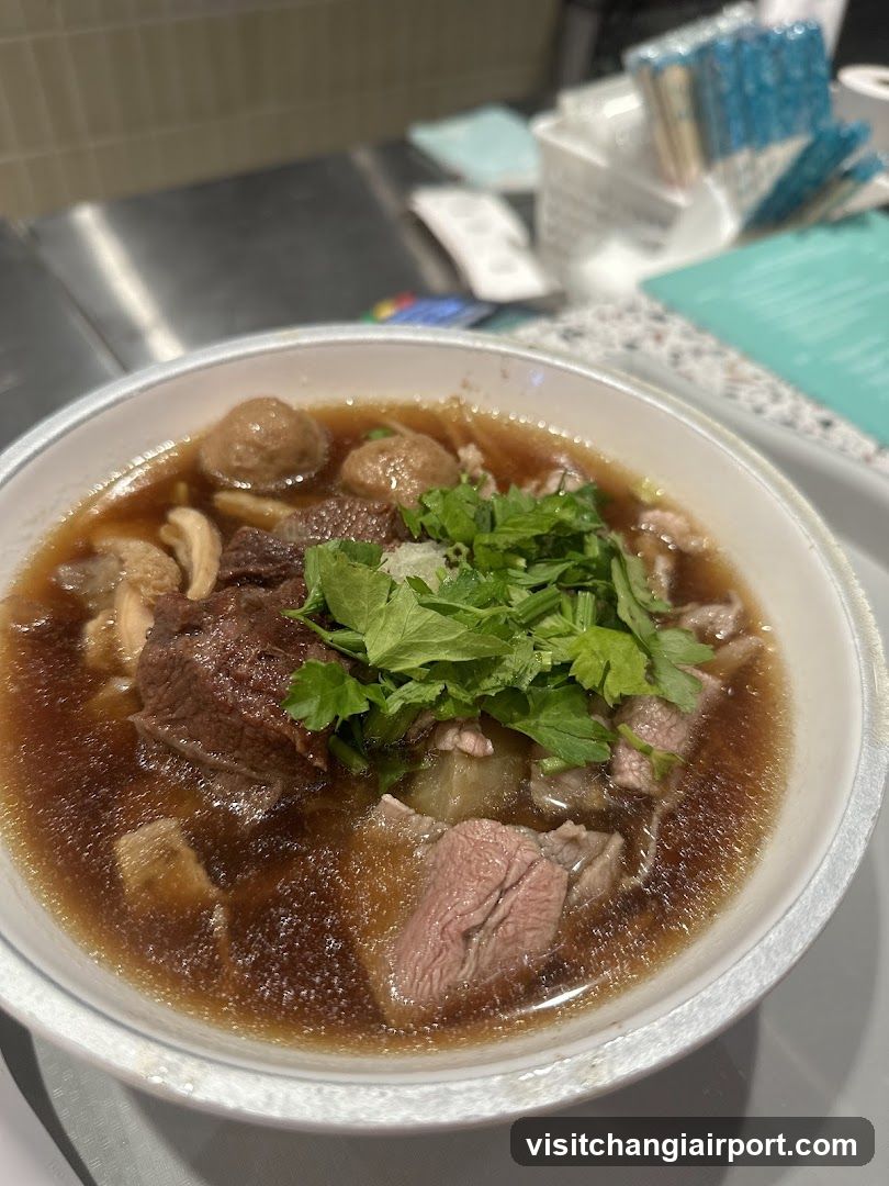 Bowl of Beef Soup with Meatballs and Cilantro