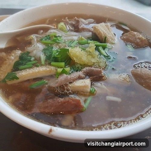 Bowl of Noodle Soup with Meat and Greens