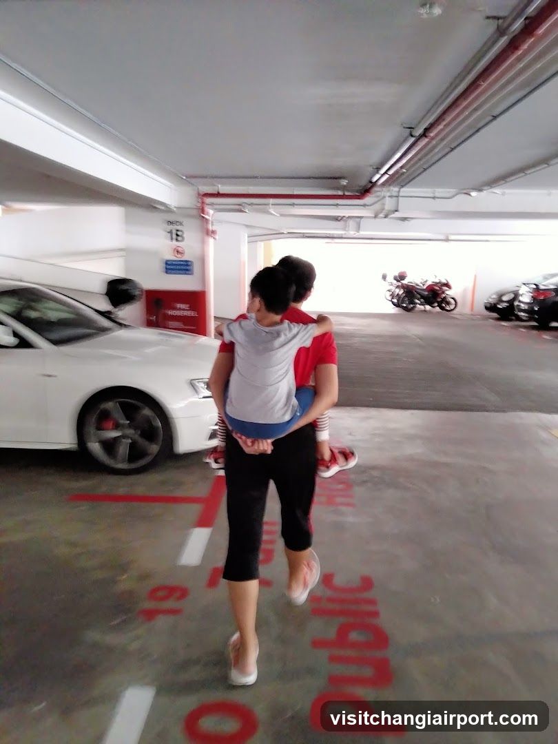Couple carrying child in parking garage