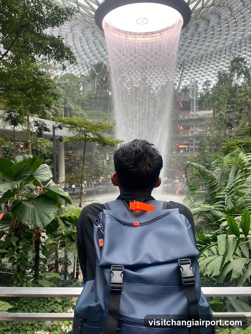 Person with Backpack at Indoor Waterfall