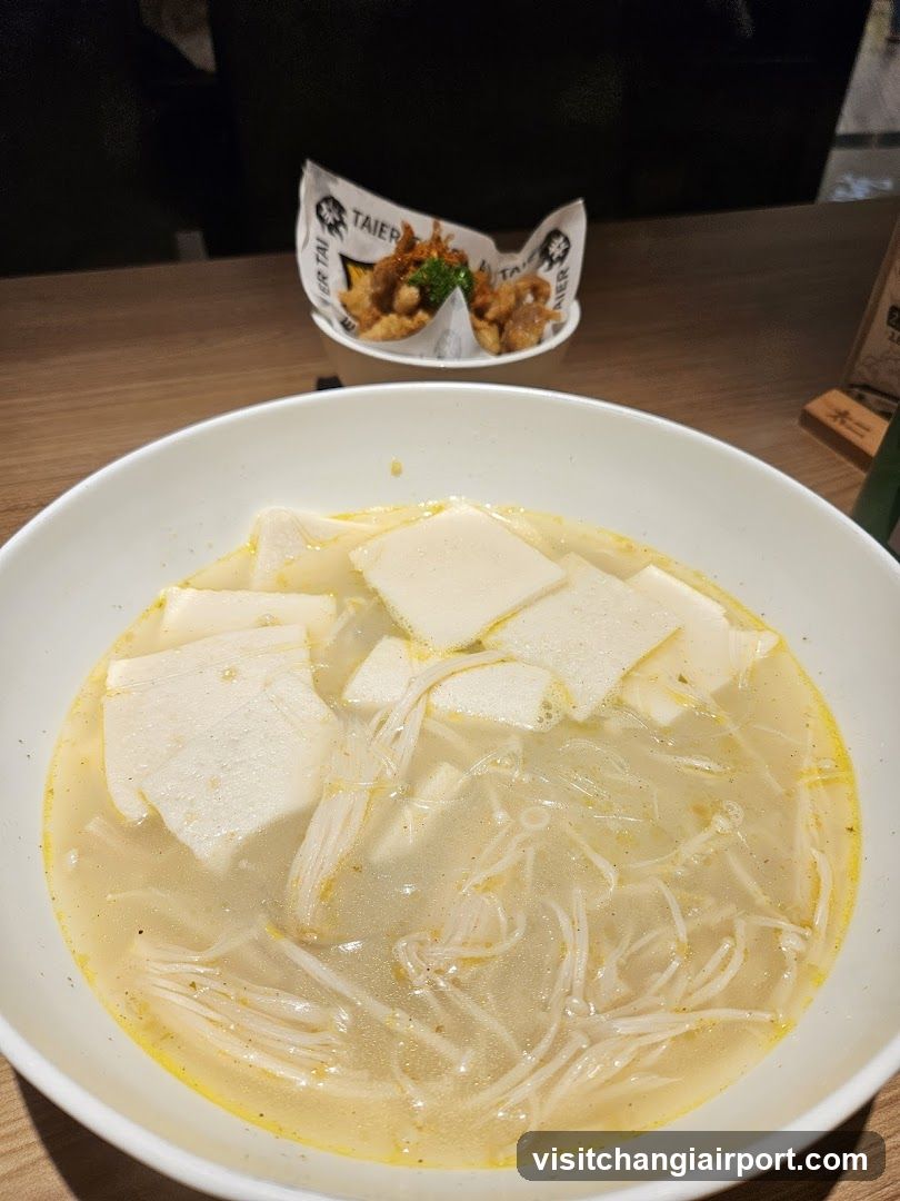 Dish with tofu and enoki mushrooms in broth
