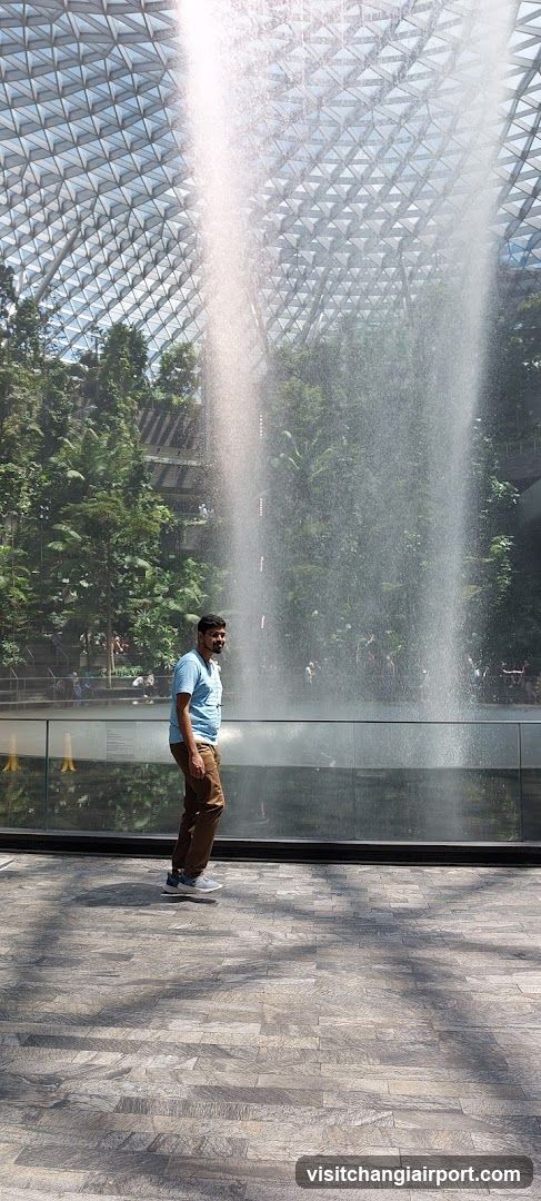 Man near water feature in indoor garden