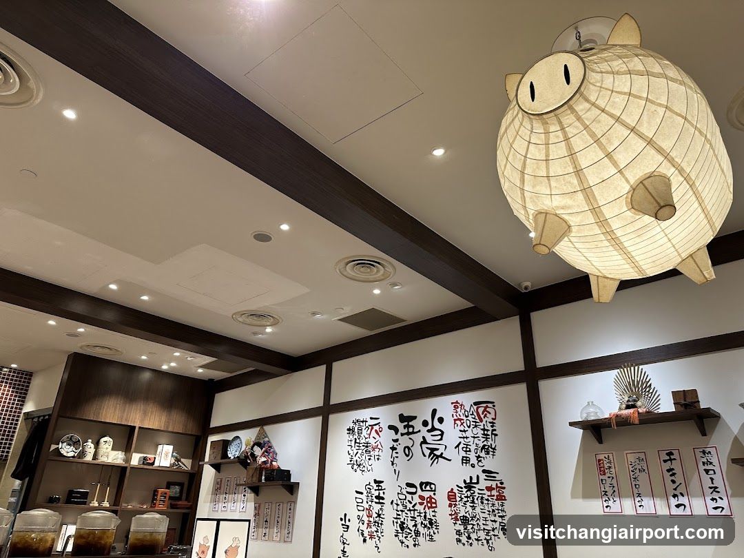Interior of a Japanese-style shop with decorative lanterns and calligraphy walls.