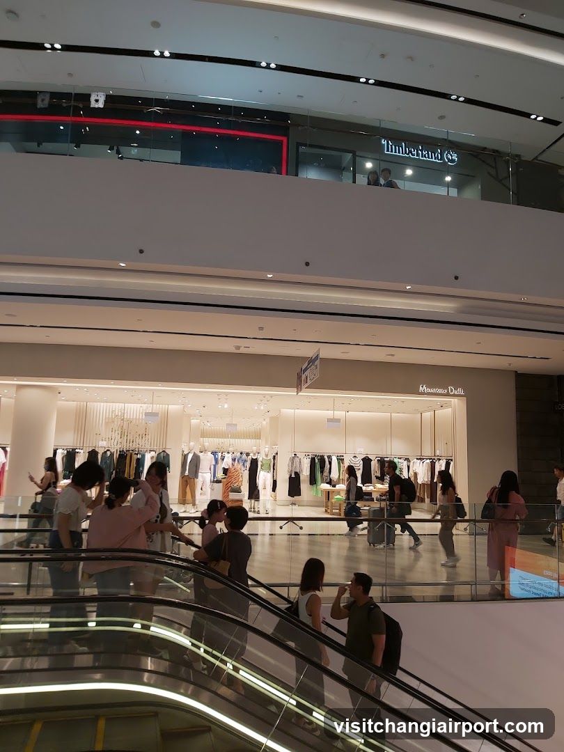 Shopping Mall Interior with Storefronts and Escalator