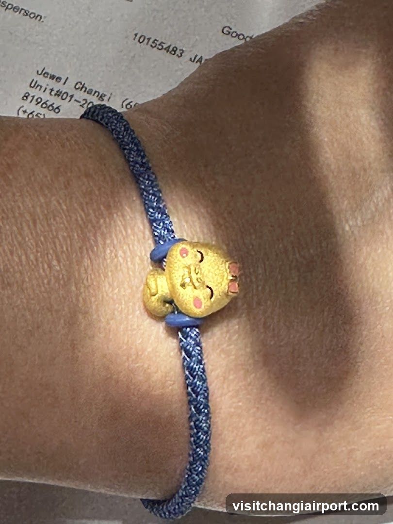 Blue braided bracelet with yellow character charm