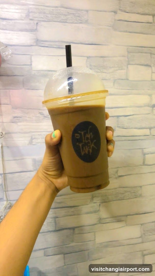Hand holding a branded drink cup