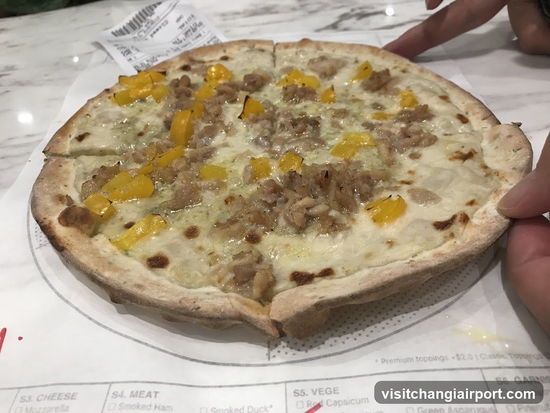 Pizza with yellow peppers and sausage