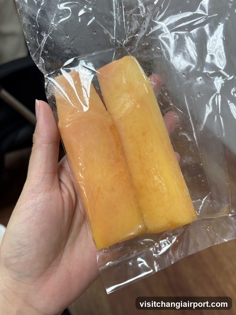 Hand holding vacuum-sealed fruit slices