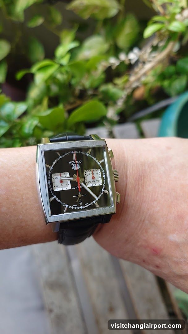 Watch on wrist with green background