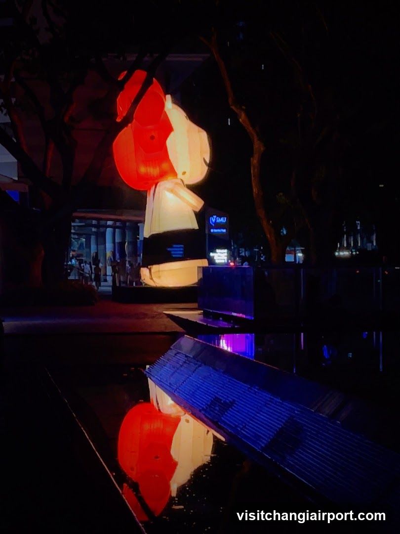 Nighttime Street Scene with Illuminated Sculpture