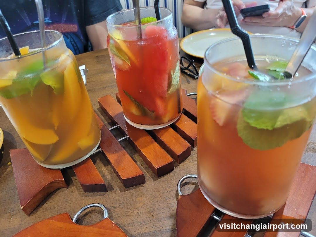 Fruit-infused drinks on wooden coasters