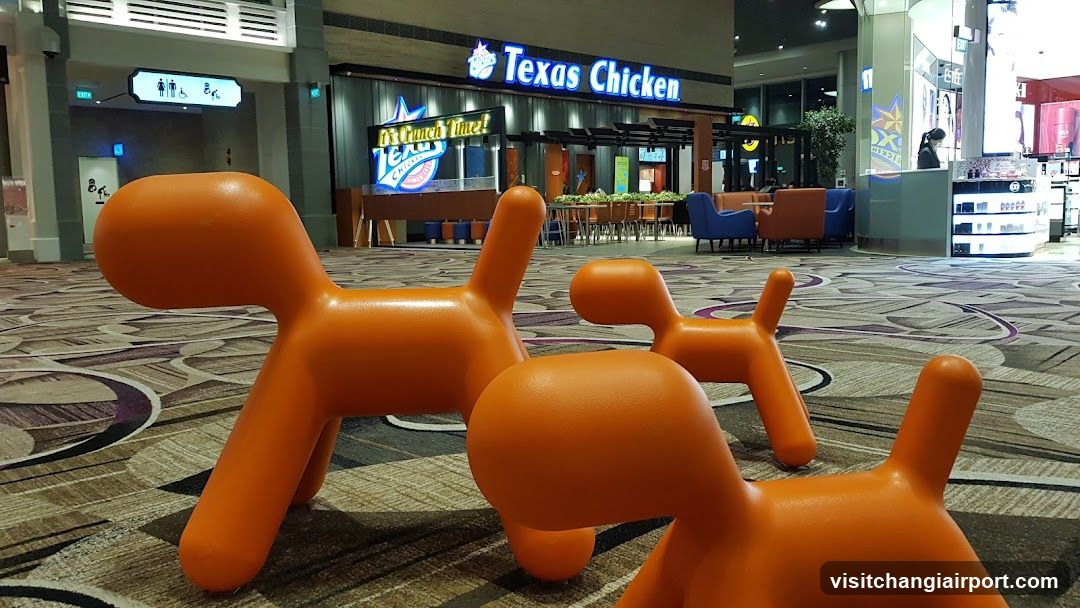 Orange Dog Sculptures in Airport Terminal