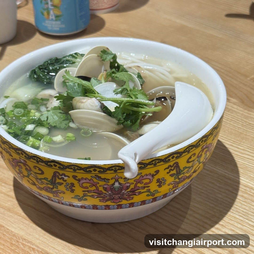 Bowl of Clam Soup with Greens and Scallions