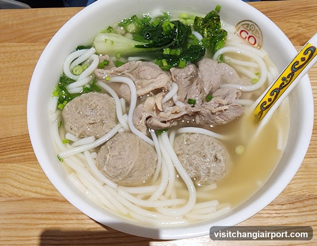 Bowl of Noodle Soup with Meatballs and Greens