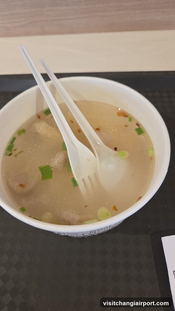Bowl of Soup with Chopsticks and Spoon