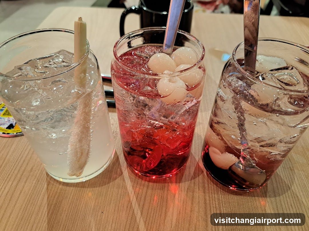 Three glasses of iced drinks on a wooden table