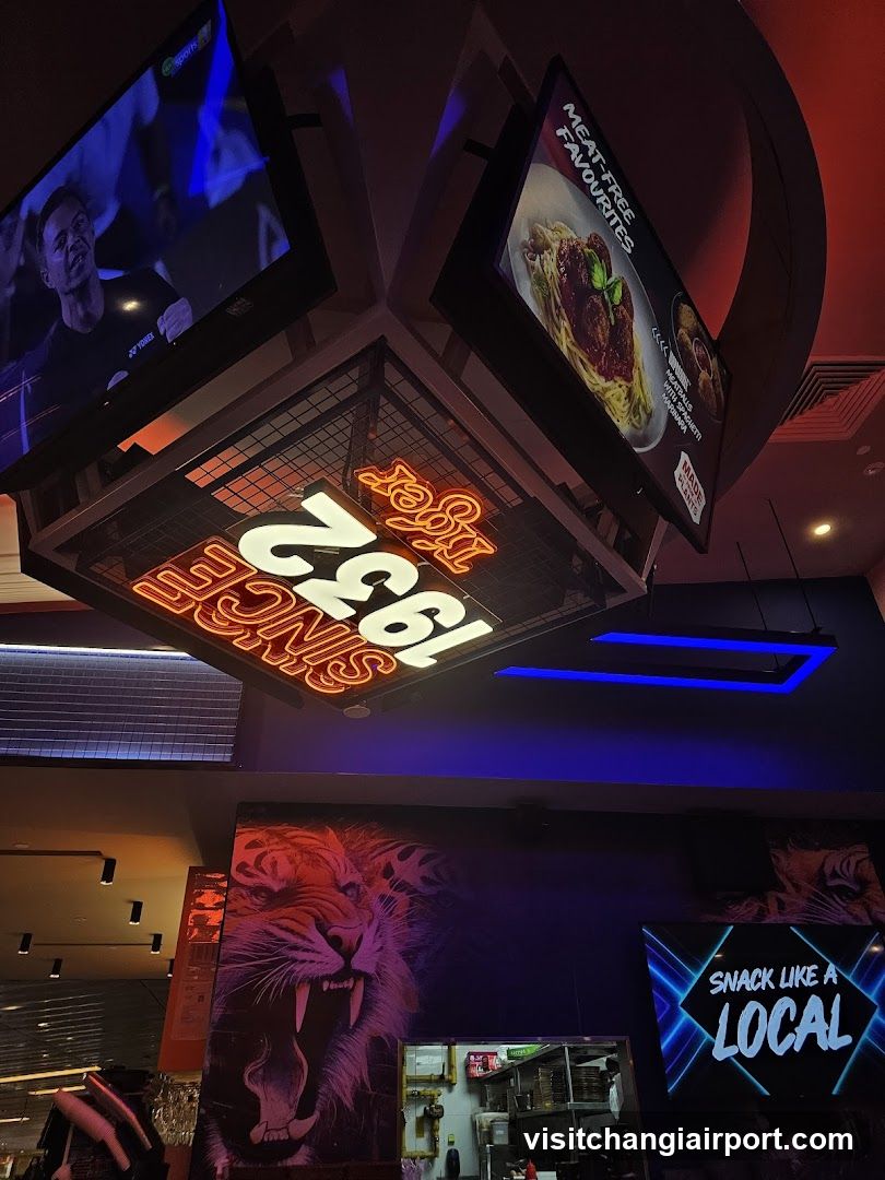 Restaurant Interior with Neon Signage and Screens