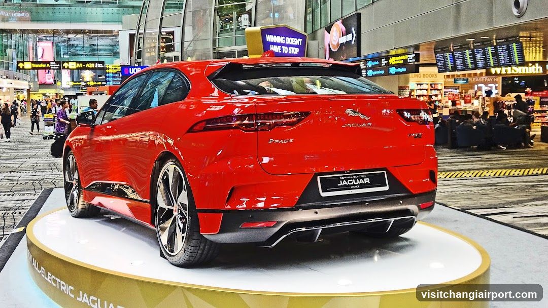 Red Jaguar I-PACE on display at airport terminal