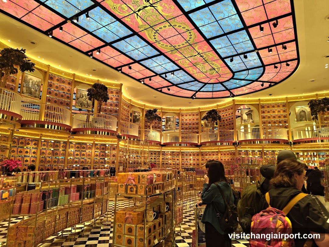 Interior of a whimsical bookstore or gift shop with stained-glass ceiling
