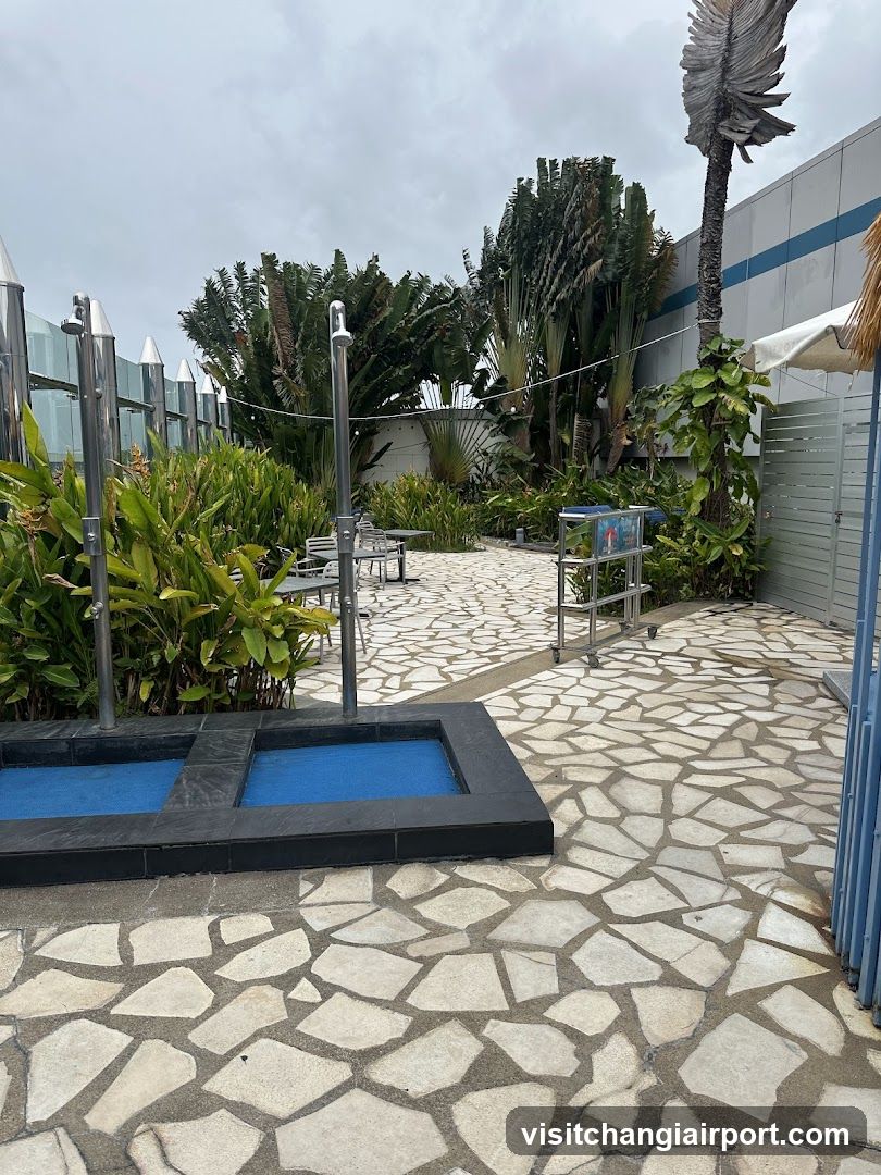 Outdoor Pool Area with Stone Paving and Greenery